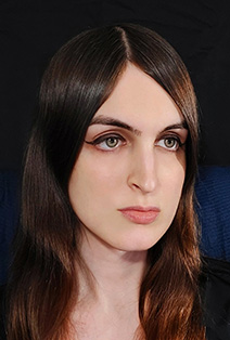 A photo of Amelie C. Langlois, the author. She has long brown hair, and green eyes.